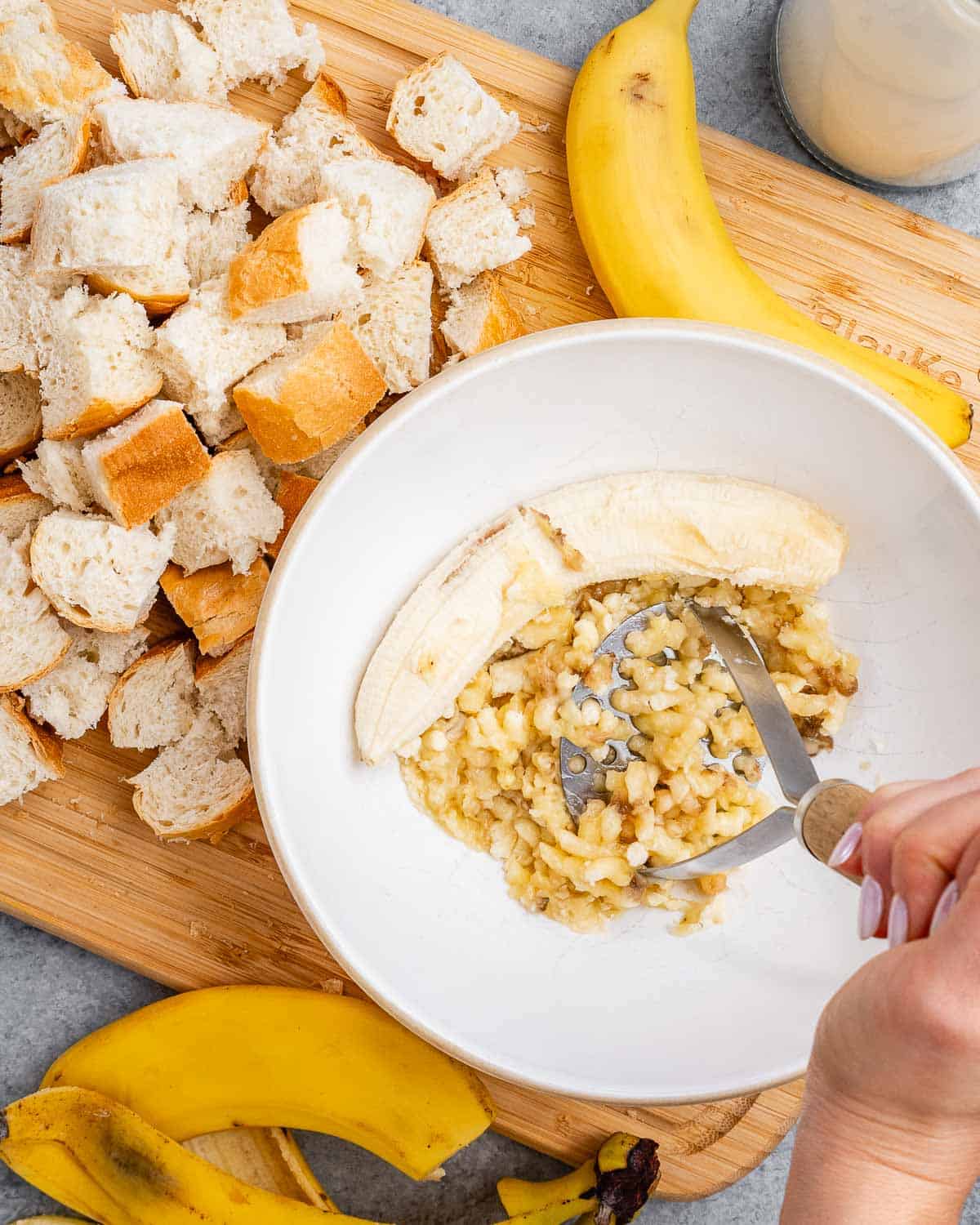 bananas being smashed in a dish.