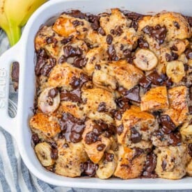 baked banana bread pudding casserole in a white dish.