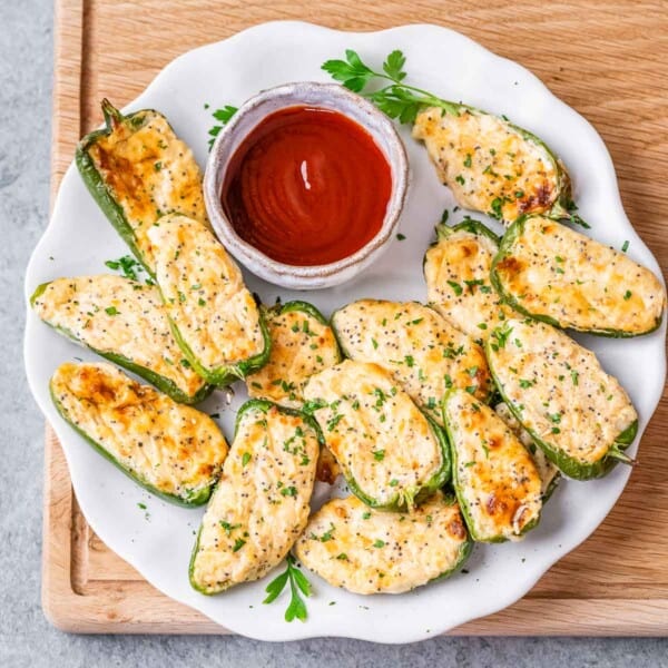 Jalapeno popper on a plate with a side of ketchup.