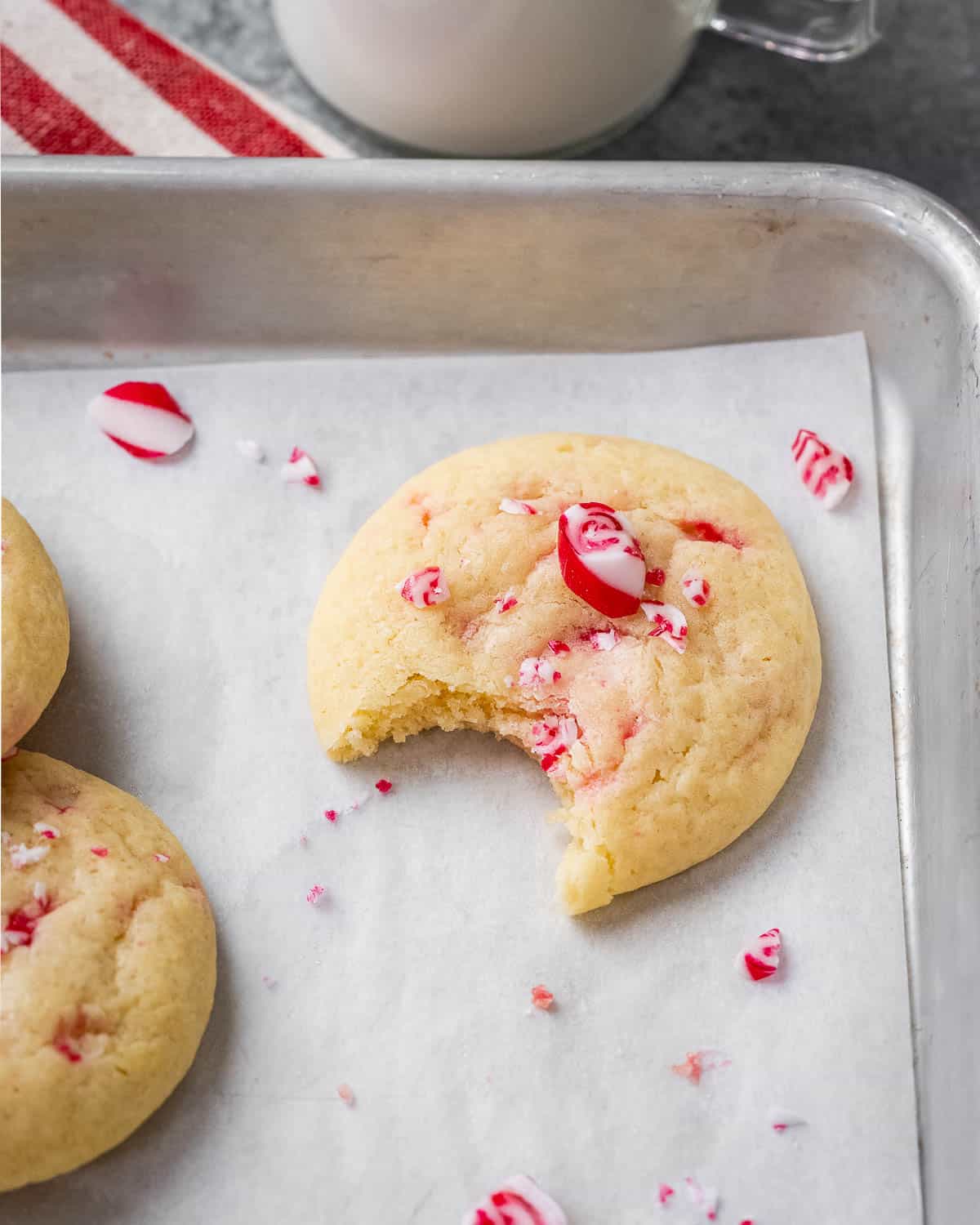 bite taken off a cookie on a sheet pan.