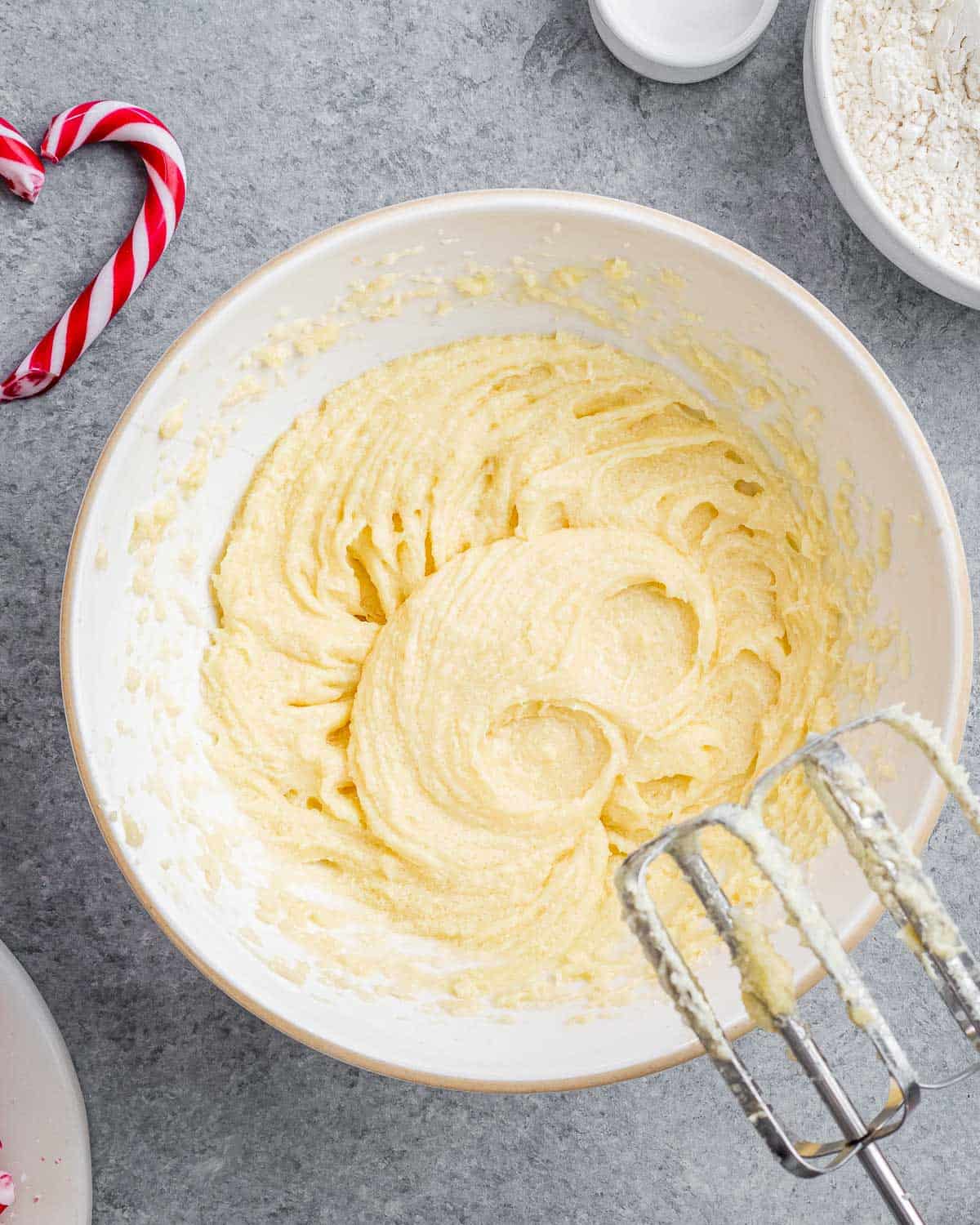 eggs and sugar whipped in a bowl with a mixer.