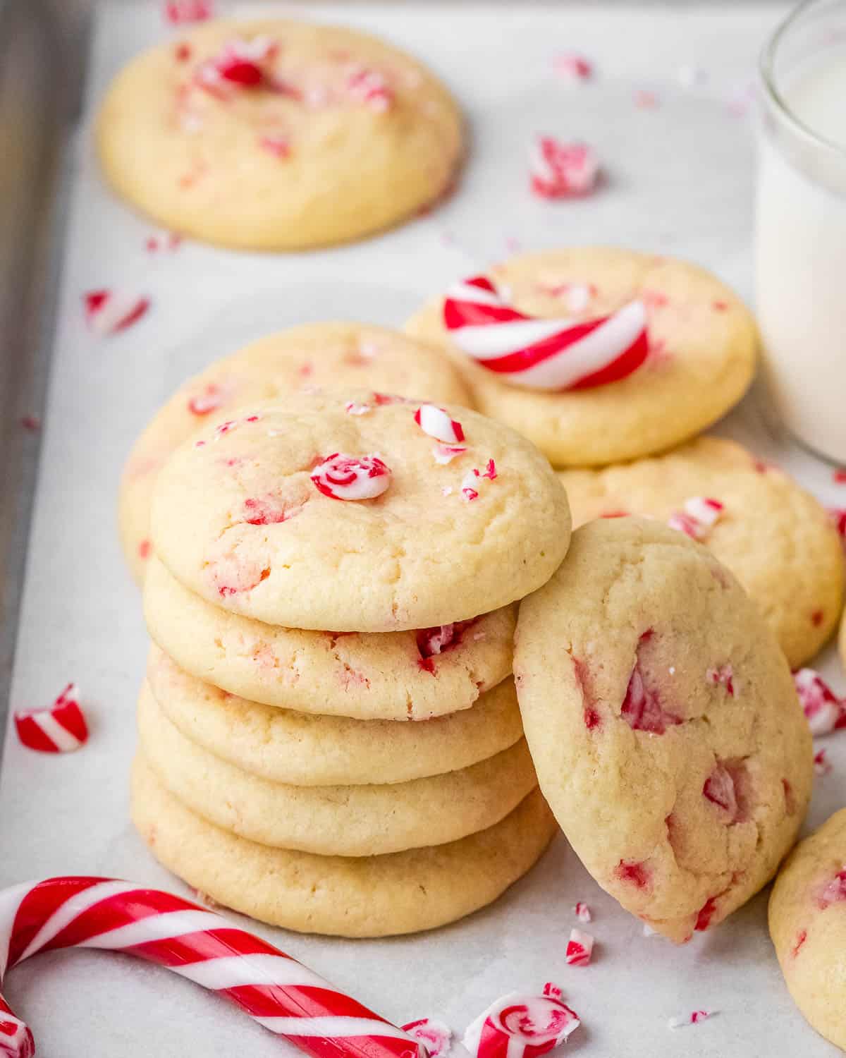 Cookies stacked on each other on a sheet pan.