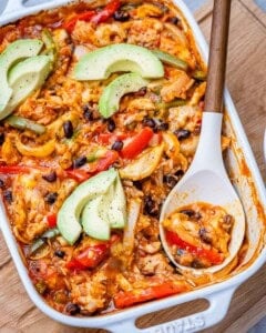 a dish with a spoon in the chicken fajita casserole.