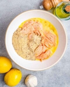 A bowl filled with ground chicken and other ingredients.