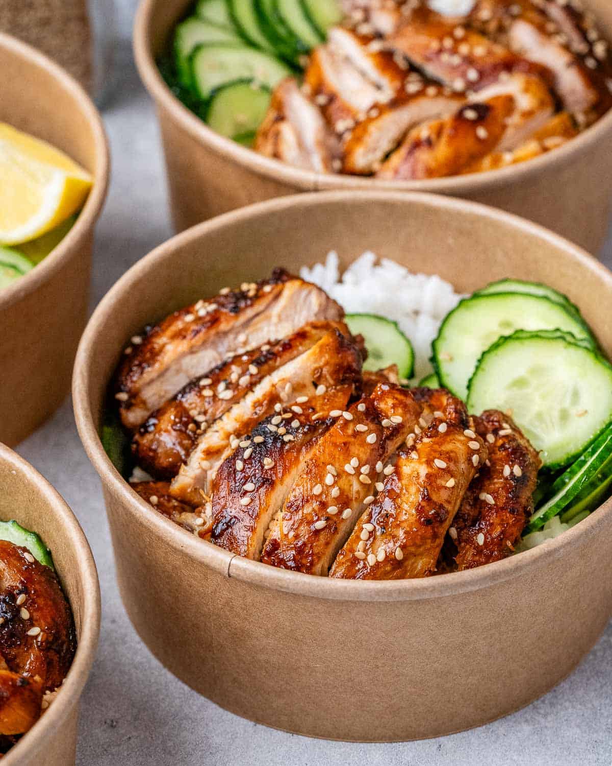 Chicken, rice, and cucumbers in a bowl.