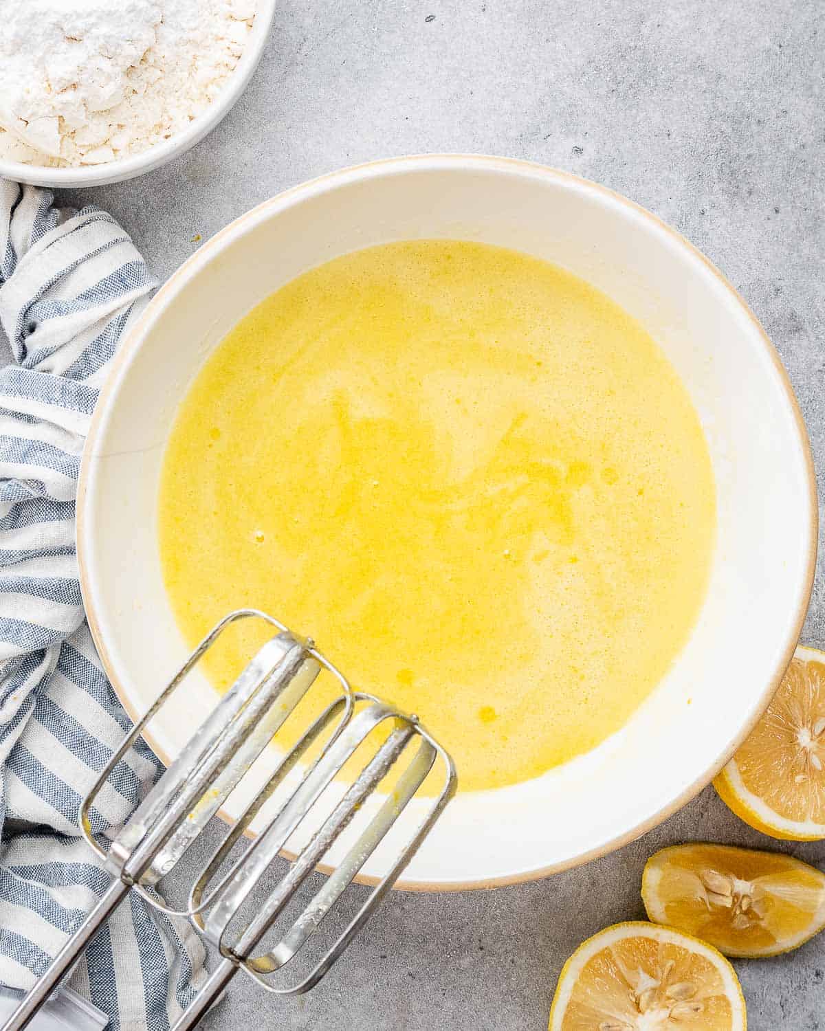 Oil and sugar whisked in a bowl.