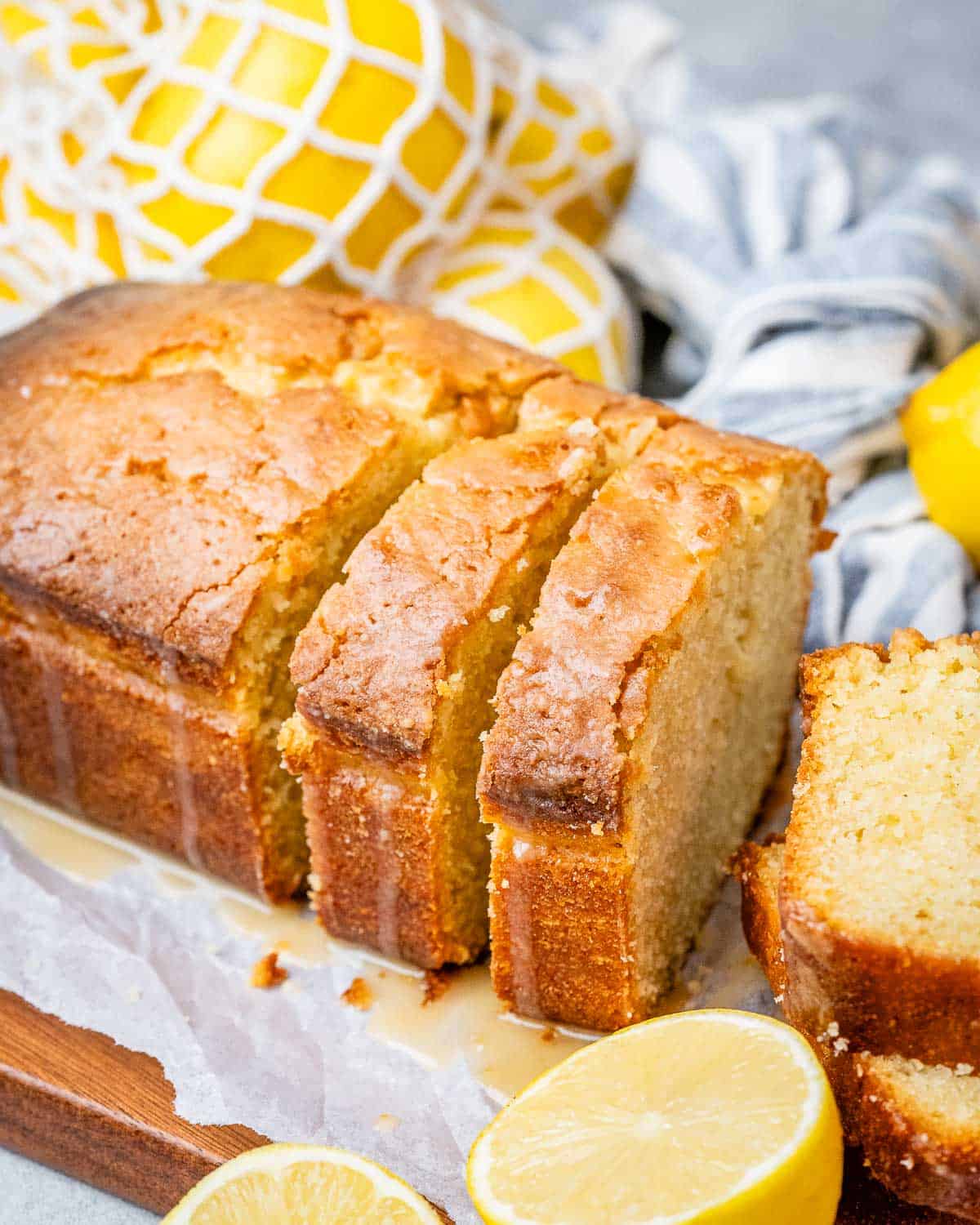 lemon cake sliced on a cutting board.