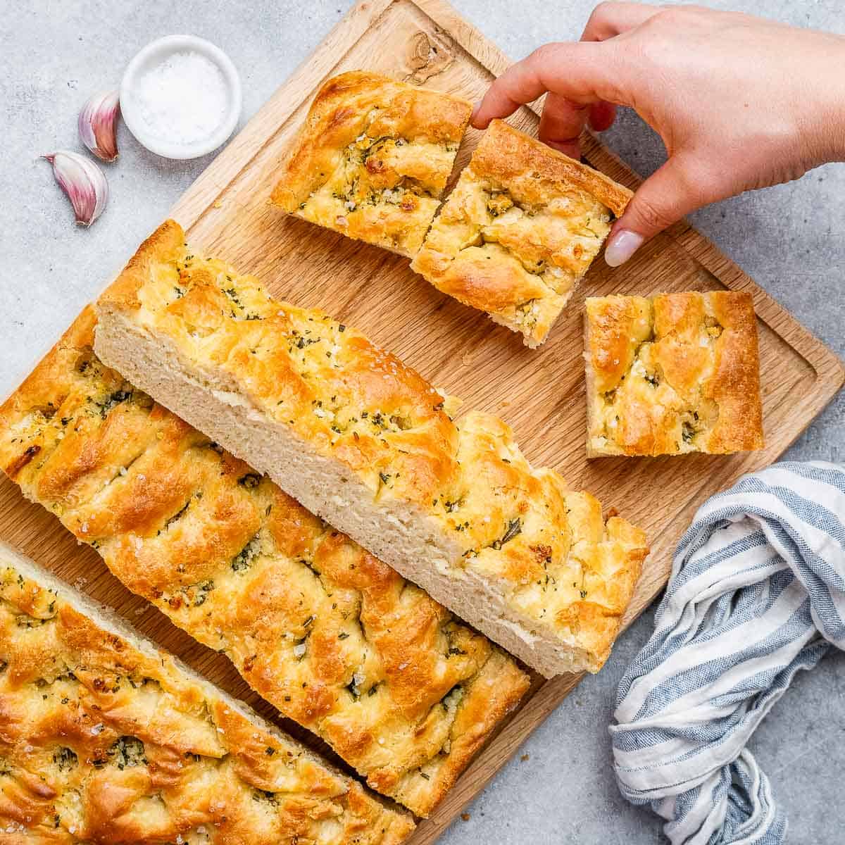 Sliced focaccia on a cutting board.