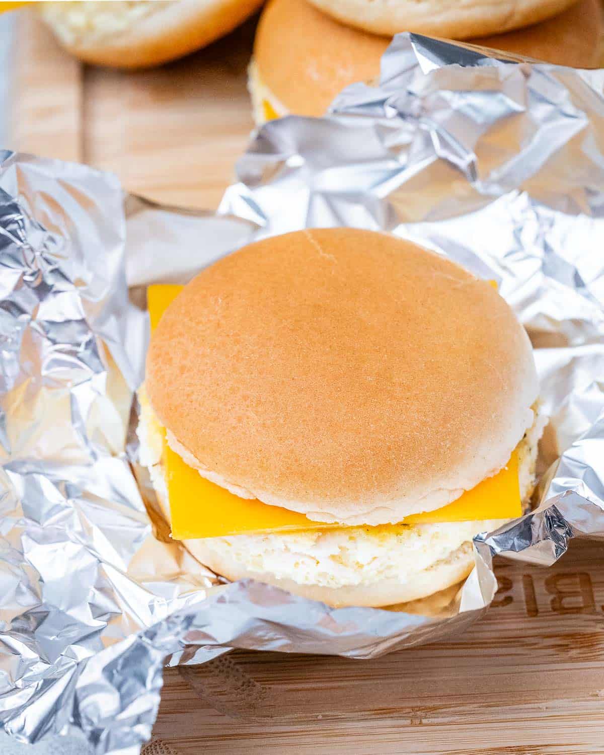 Breakfast sandwich sitting on aluminum foil.