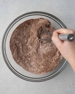 flour and cocoa powder are mixed in a bowl.