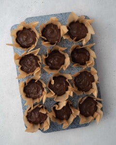 A batter is added to the cupcake liner to be baked.