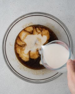 Milk is poured into the egg and sugar batter.