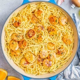 Overhead shot of scallop spaghetti served in a wide skillet.