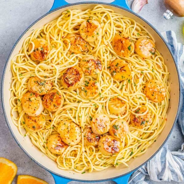 Overhead shot of scallop spaghetti served in a wide skillet.