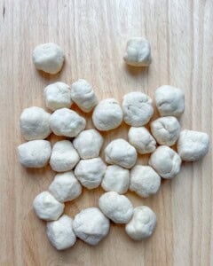 stuffed dough balls placed on a flat surface.