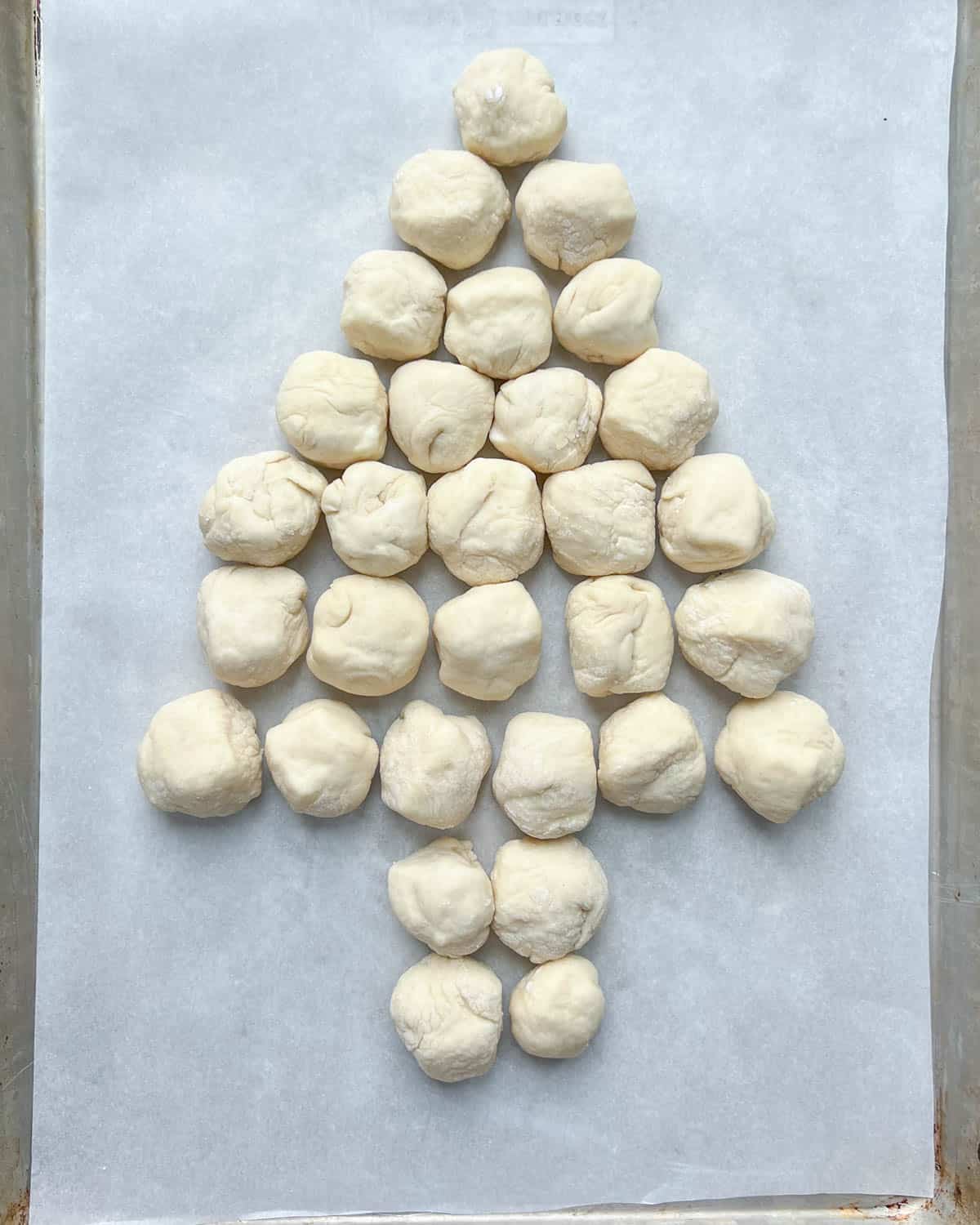 dough before baking placed on a sheet pan in a tree-like manner.