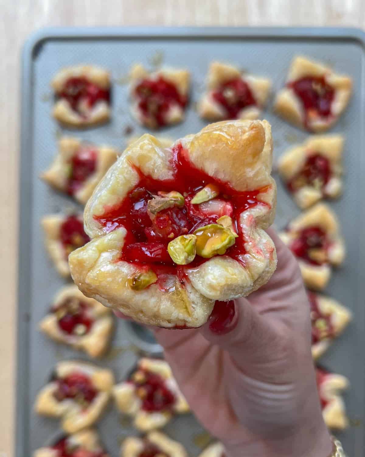 hand holding a brie bites.