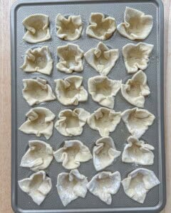 push the pastry squares added into each muffin tin.