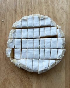 Brie cut into many pieces.