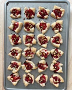 baked brie bites with cranberry sauce still in muffin tin pan.