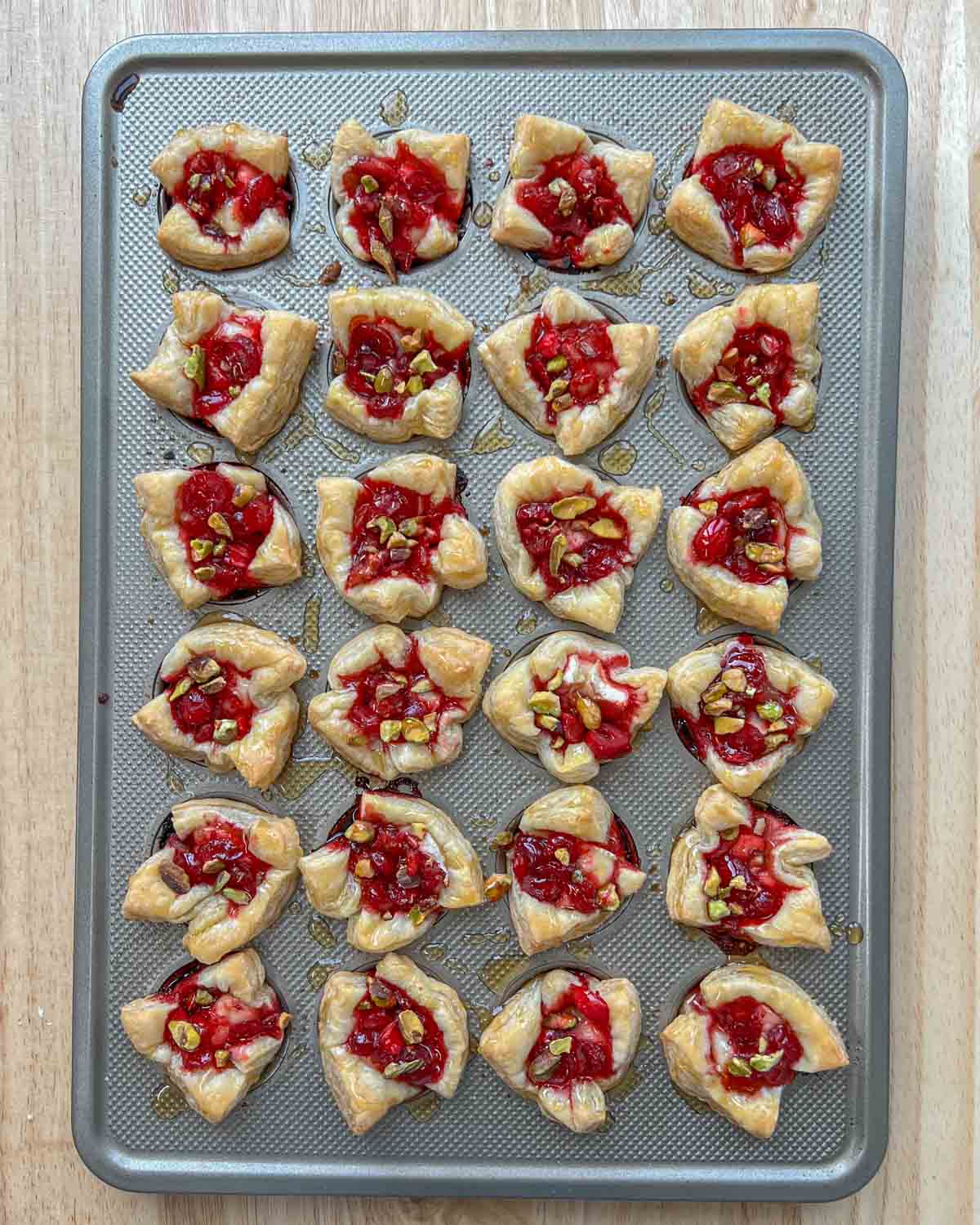 baked brie bites in a muffin pan.