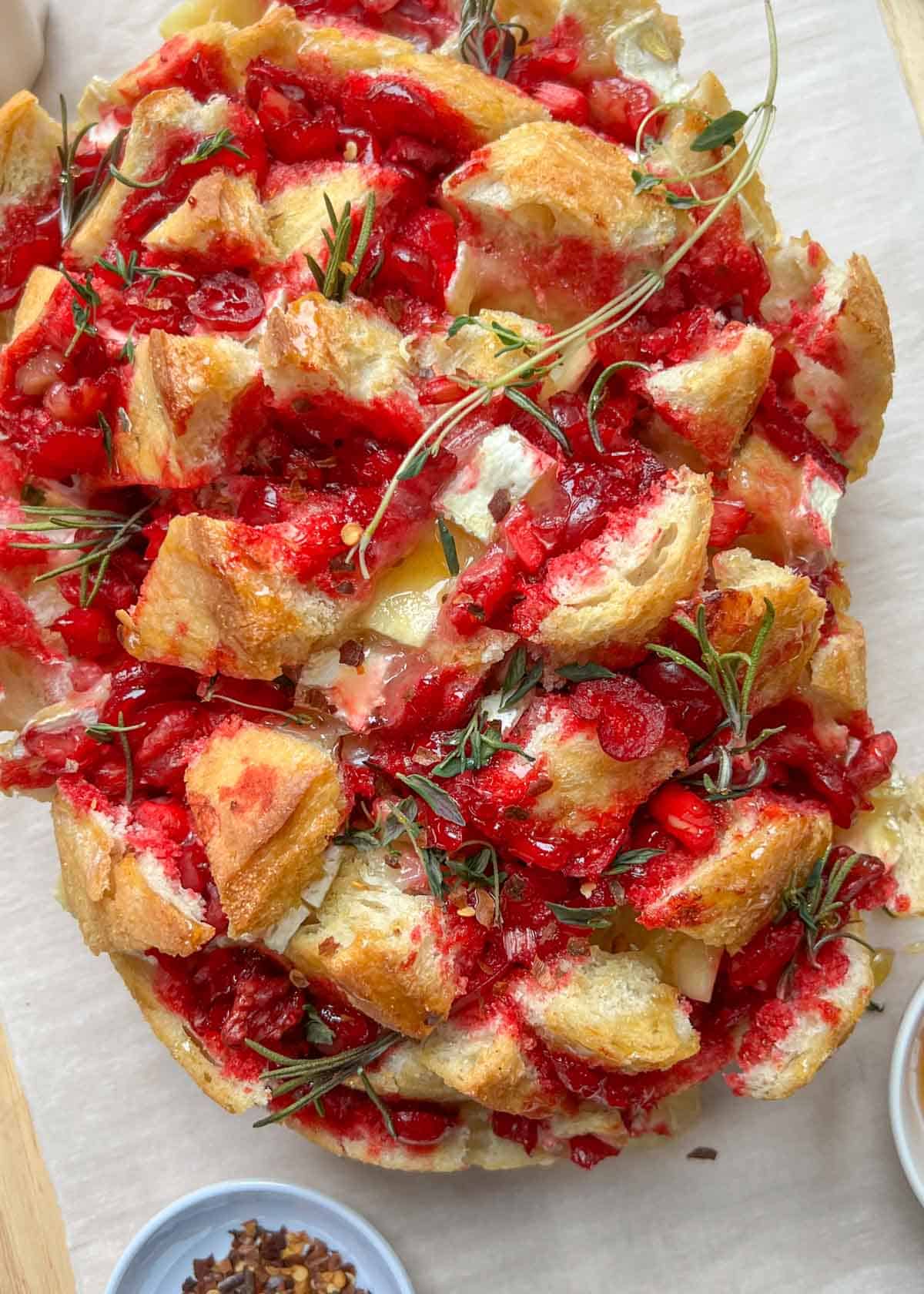 baked bread with cranberry sauce and brie cheese.