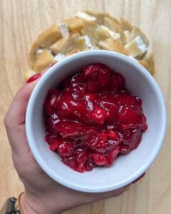 bowl of cranberry sauce over bead.