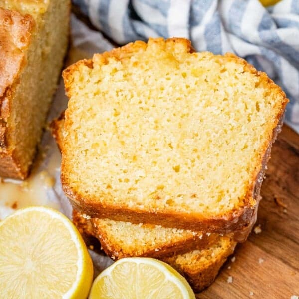 3 slices of lemon cake on a cutting board.