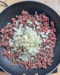 diced onions, salt, and pepper added over cooked minced meat.