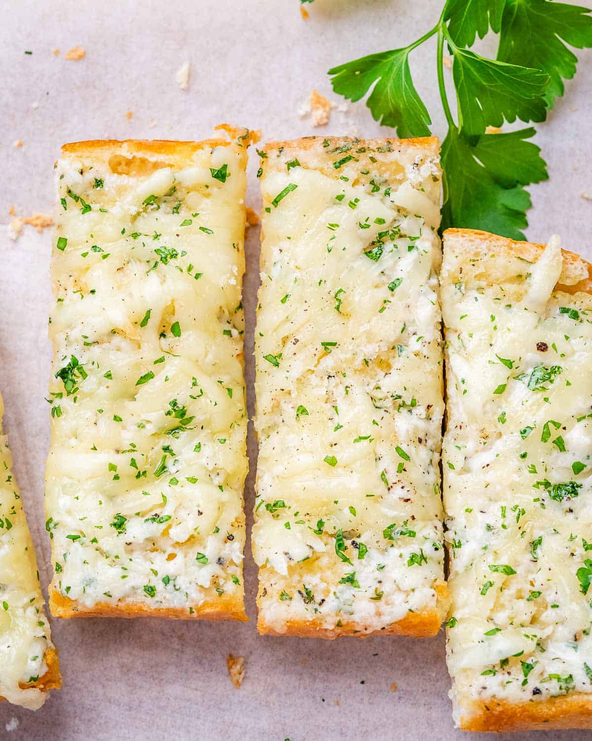 garlic bread sliced on a cutting board.