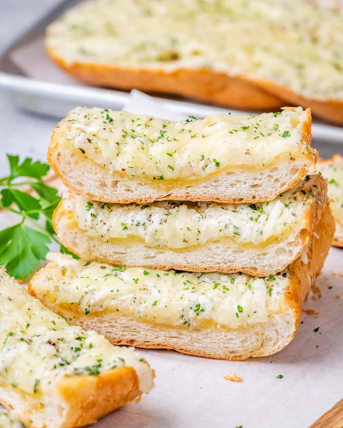 pieces of garlic bread stacked over each other.