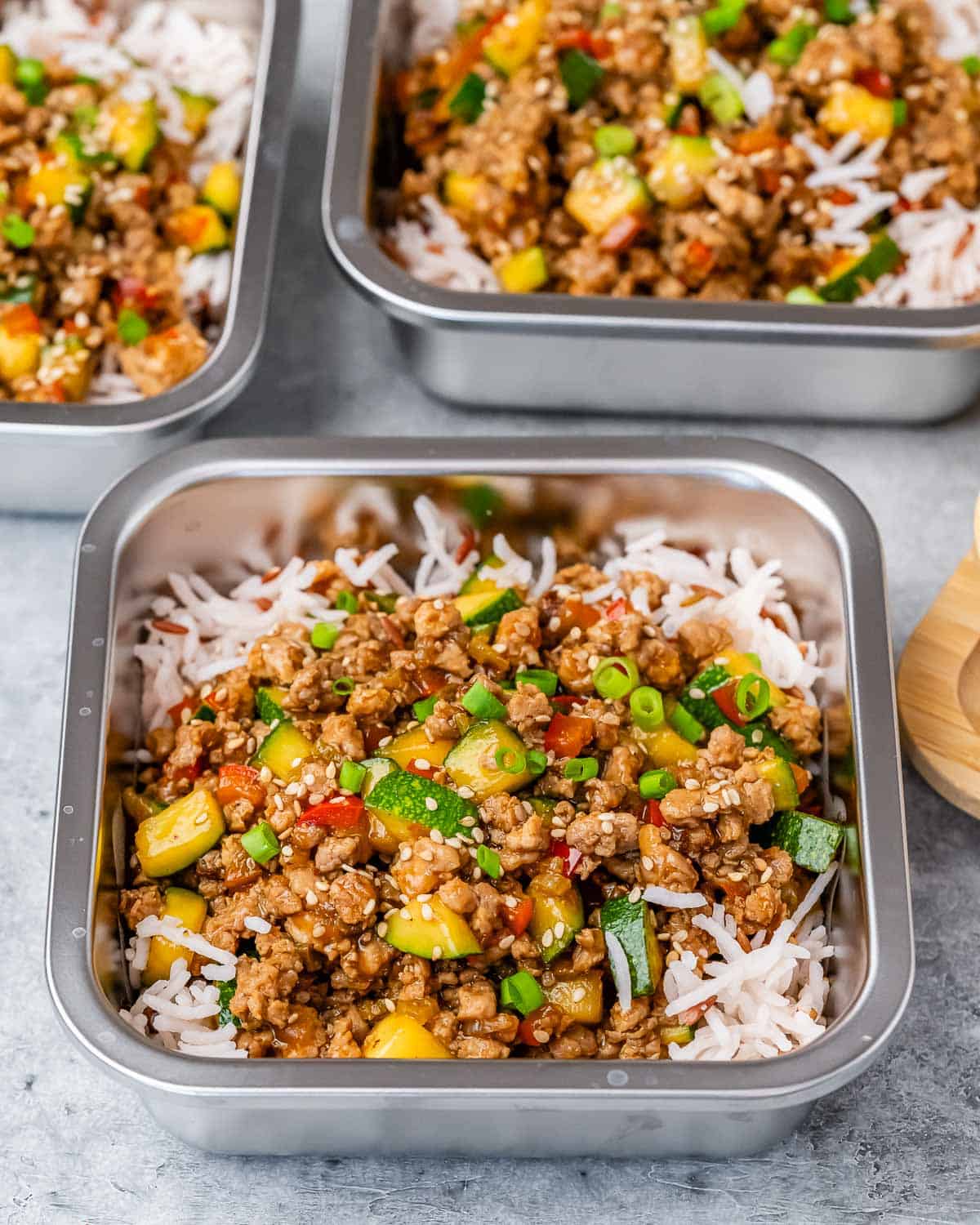 Turkey stir fry on top of rice in square containers.