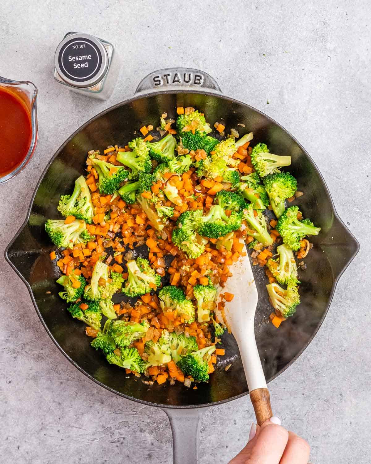 Stirring vegetables in a skillet.