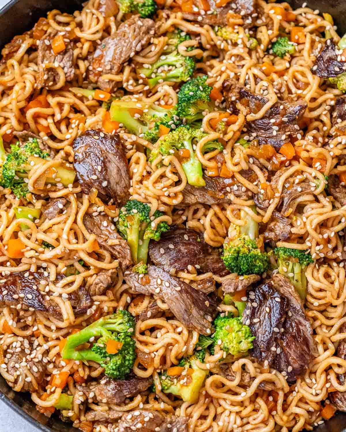 Close up of beef lo mein in a skillet.