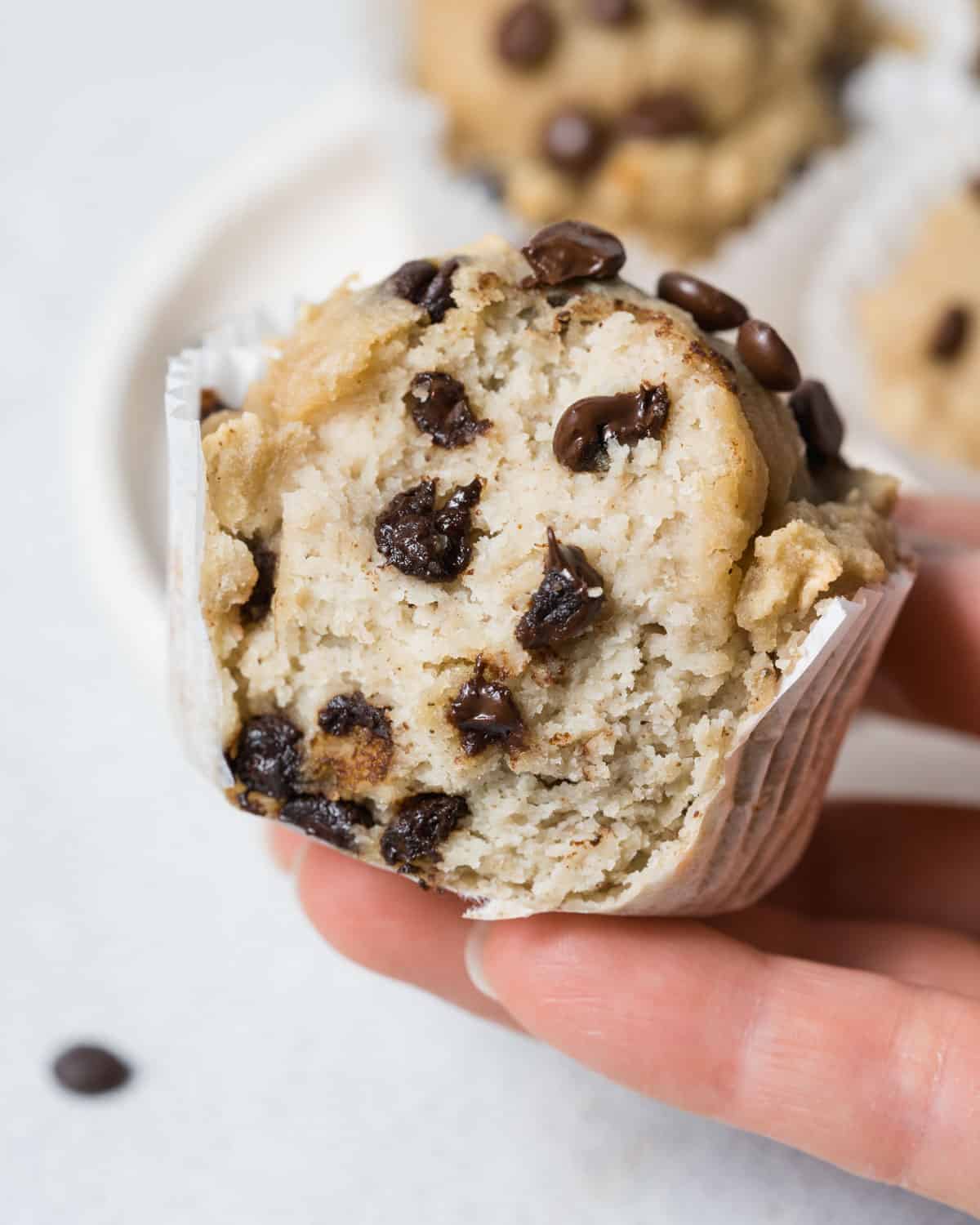 hand holding muffin cut in half.