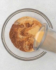 cottage cheese mixture being added over the flour mixture in a bowl.