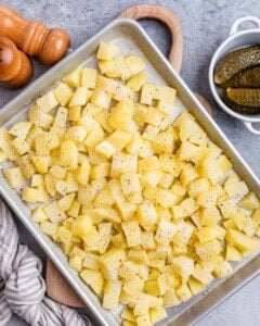 Cubed potatoes on a baking sheet.