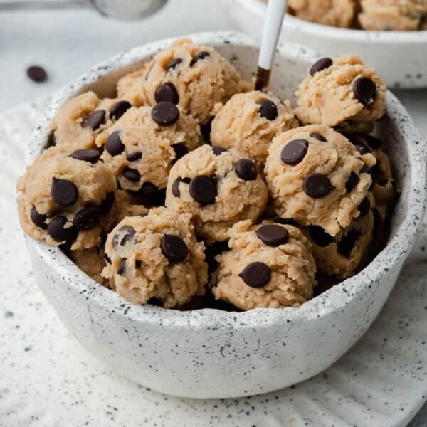 edible cookie dough balls in a white bowl.
