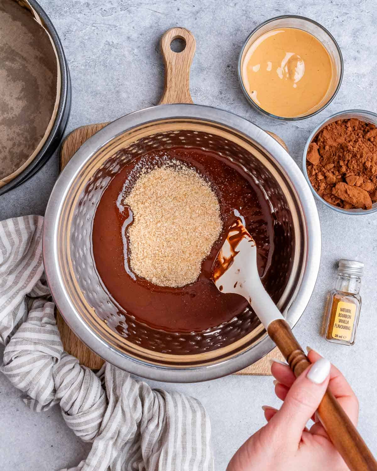 A spatula stirring dry and wet ingredients together.