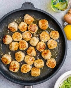 Cooked meatballs in a cast iron skillet.