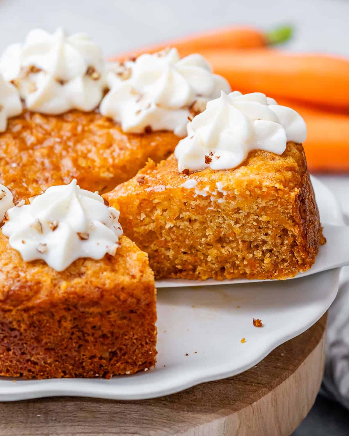 A spatula lifting a slice of cake away from the rest of the cake.