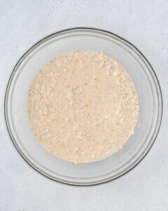 oats mixed with milk and yogurt in a bowl.