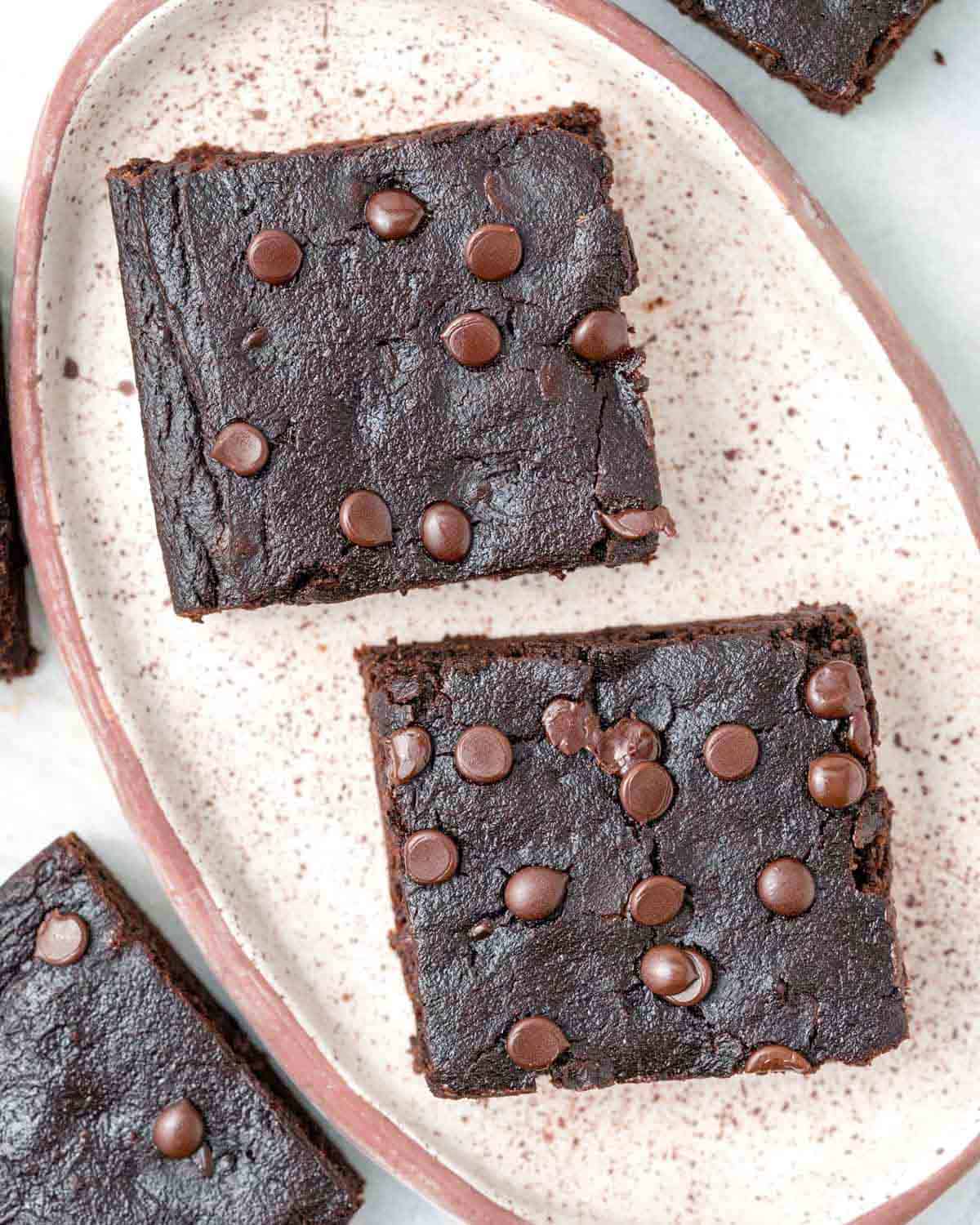 two brownie squares on a plate.