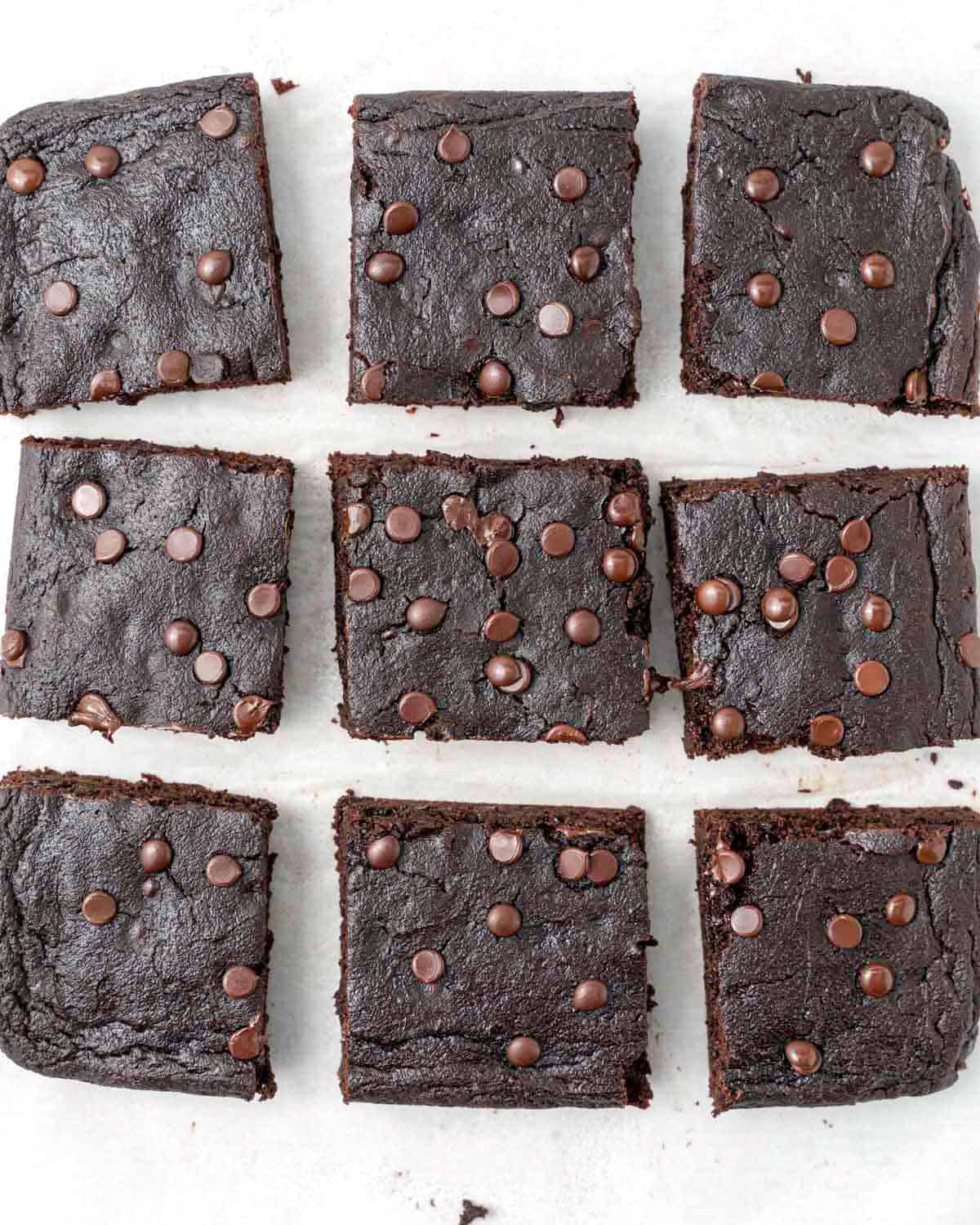 9 brownie squares on parchment paper.