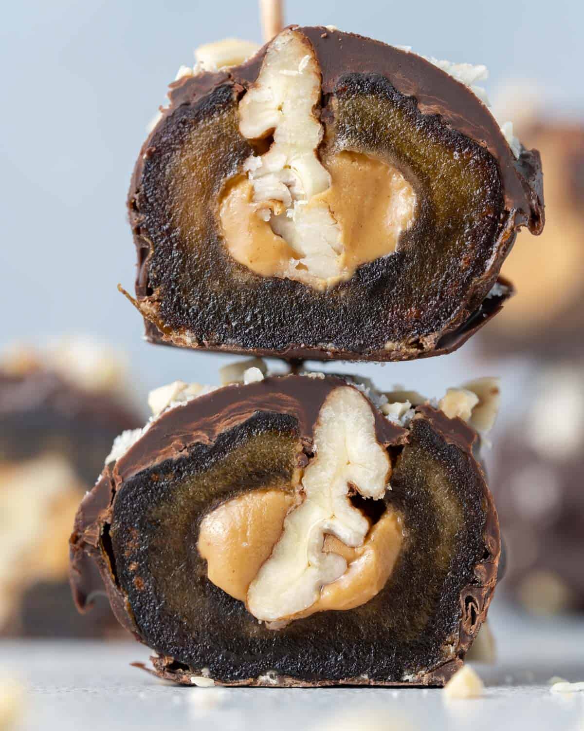 Another halved date Snickers, zoomed in to highlight the rich layers of date, peanut butter, and pecan