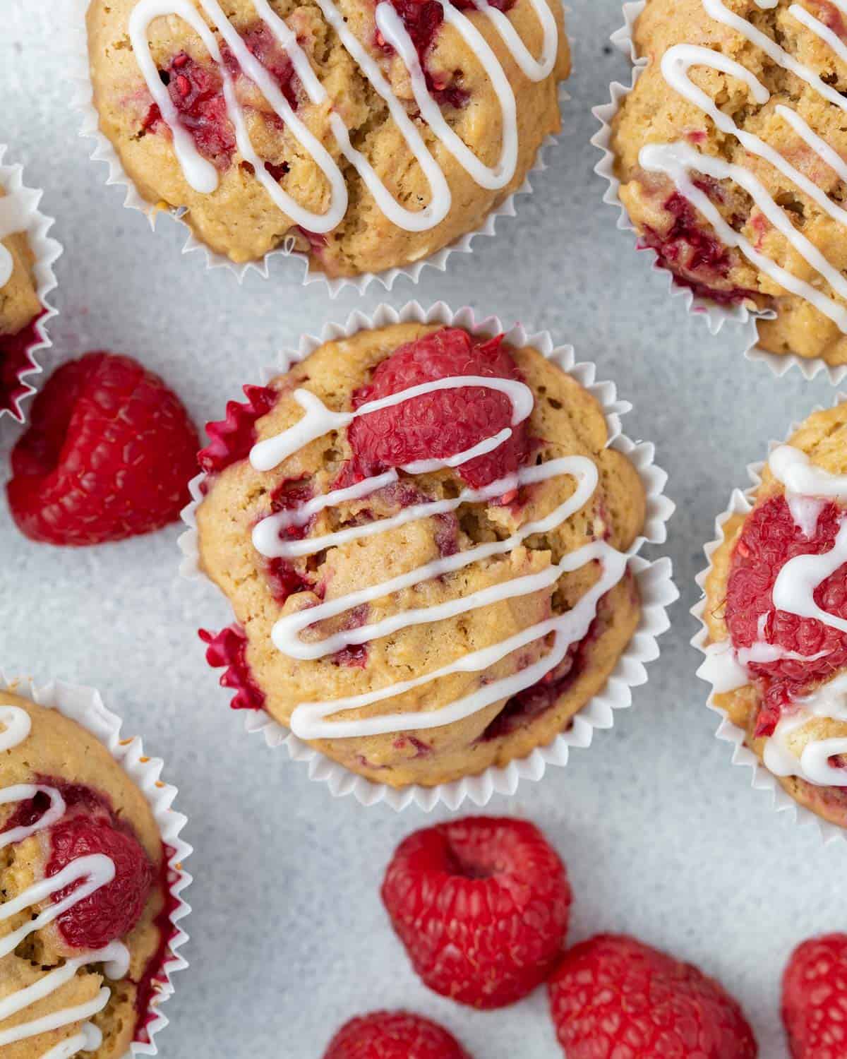 Raspberry muffin on a flat surface, topped with sugar glaze.