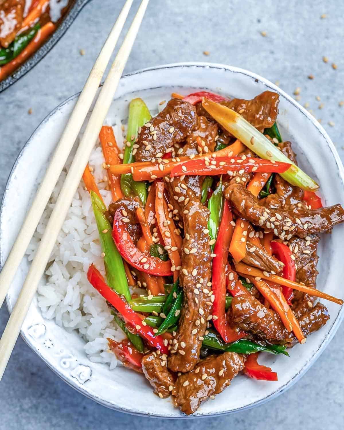 a bowl with rice topped with mongolian beef.