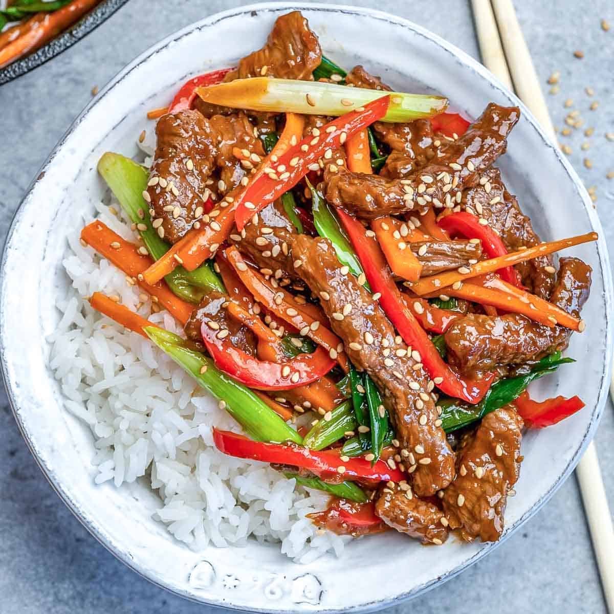 a rice bowl topped with mongolian beef stir fry.