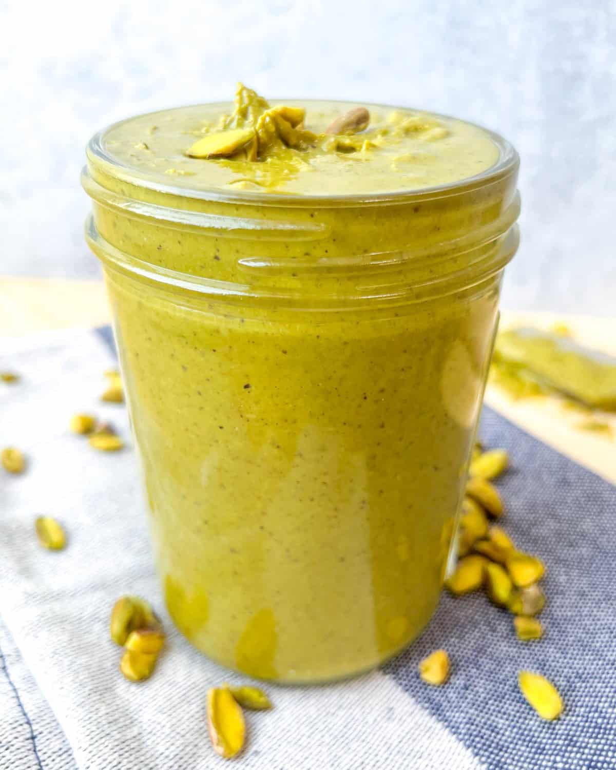 a jar filled with pistachio cream. 