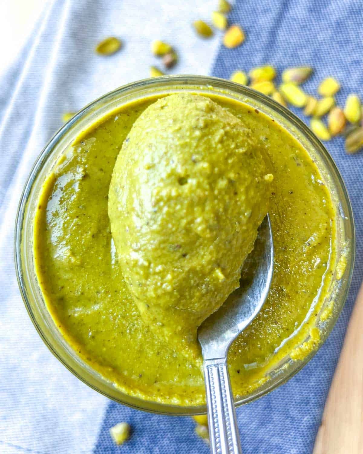 a spoonful of pistachio cream from a jar.